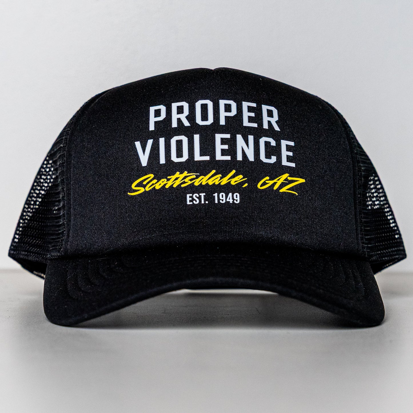 Front view of Proper Violence Scottsdale AZ Trucker Hat with logo