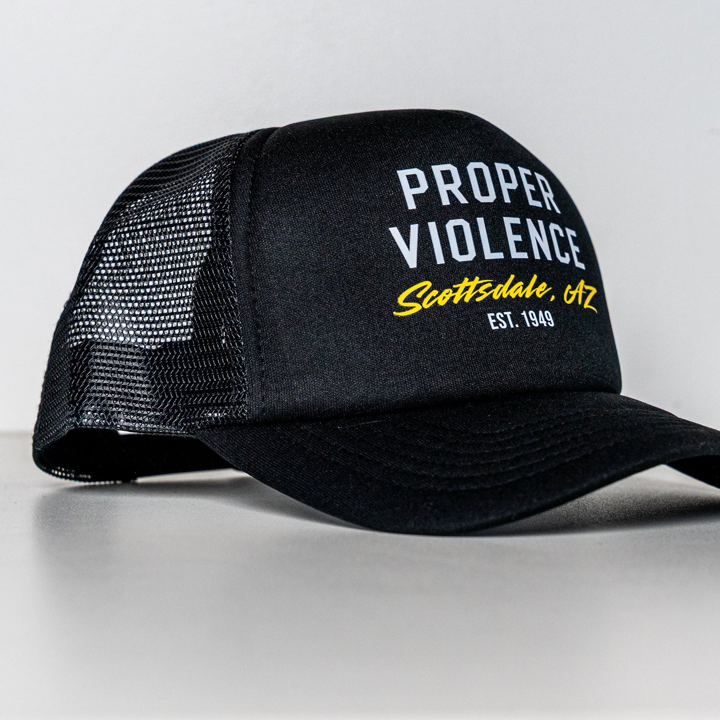 Side view of Proper Violence Scottsdale AZ Trucker Hat with logo
