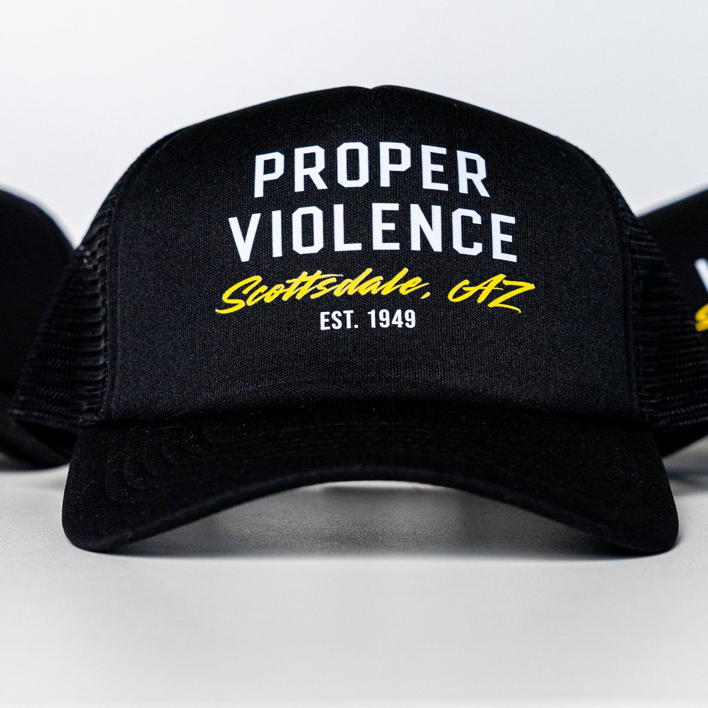Front view of Proper Violence Scottsdale AZ Trucker Hat with logo